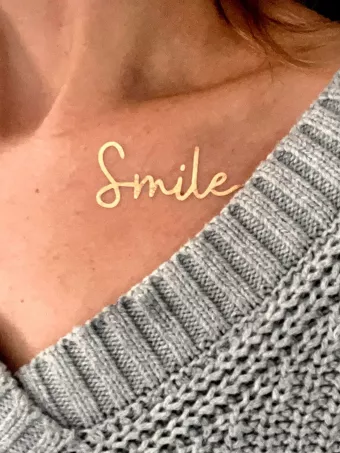 Gold smile tattoo